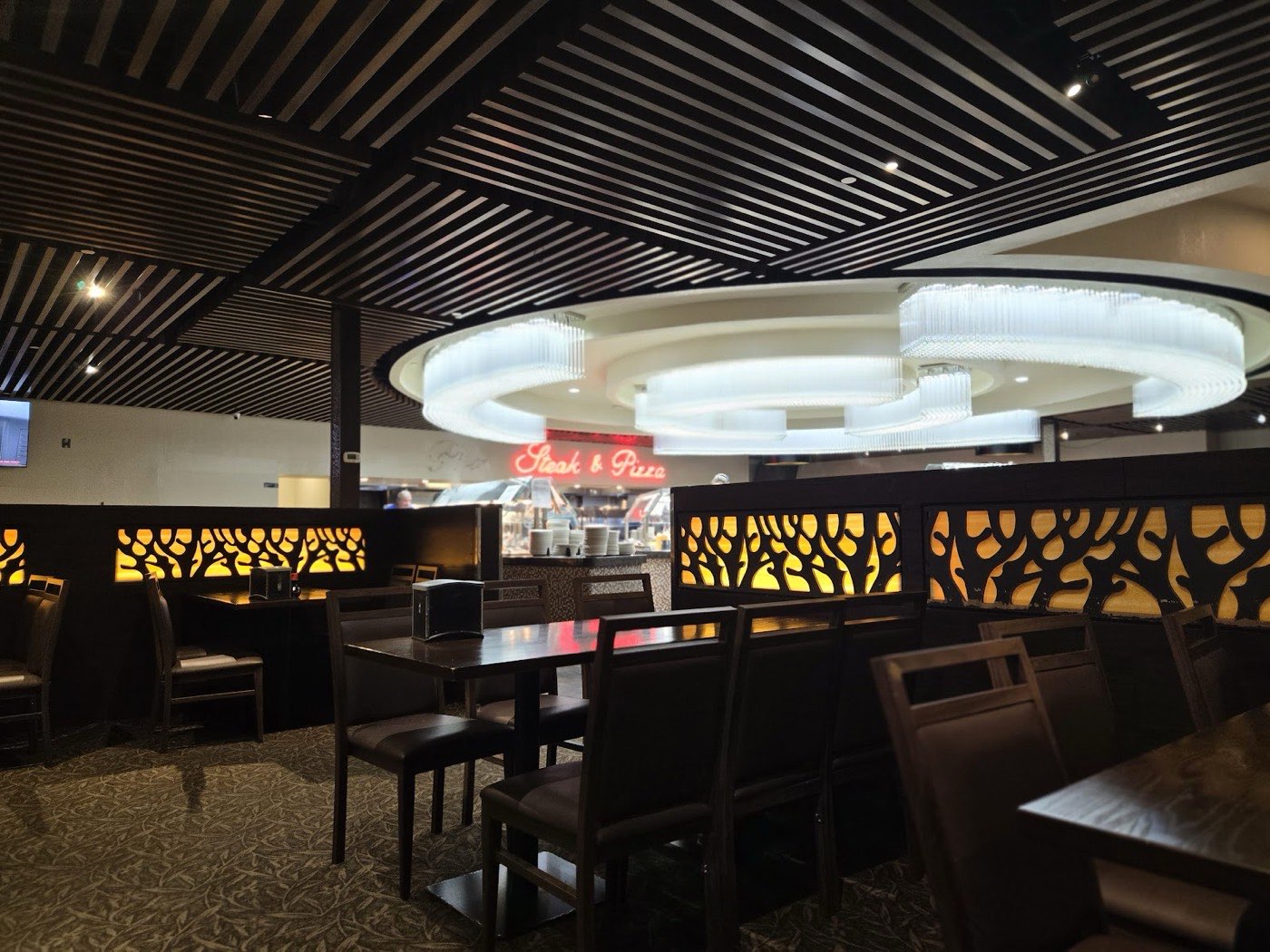 Bright dining room with statement chandeliers at Kin's Chinese Buffet